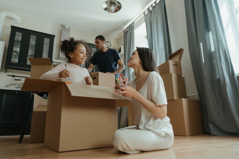 A joyful family unpacking boxes while moving into their new home